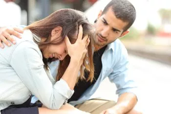 Man consoling crying woman