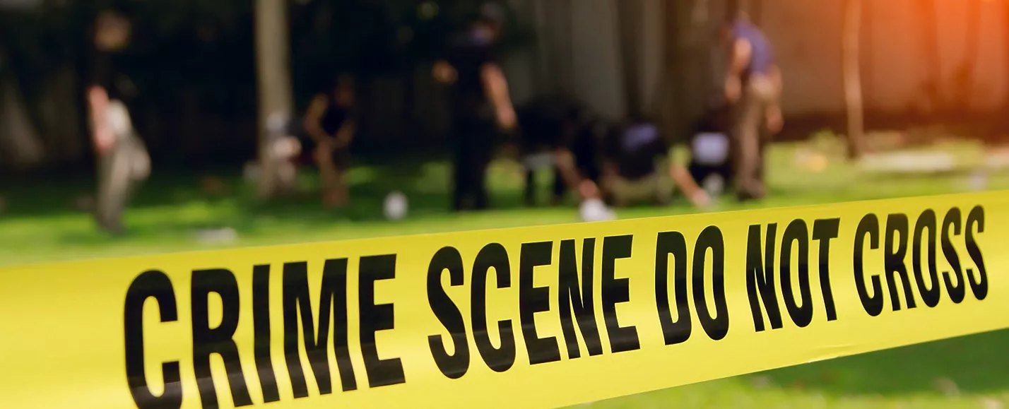 Crime scene tape on lawn